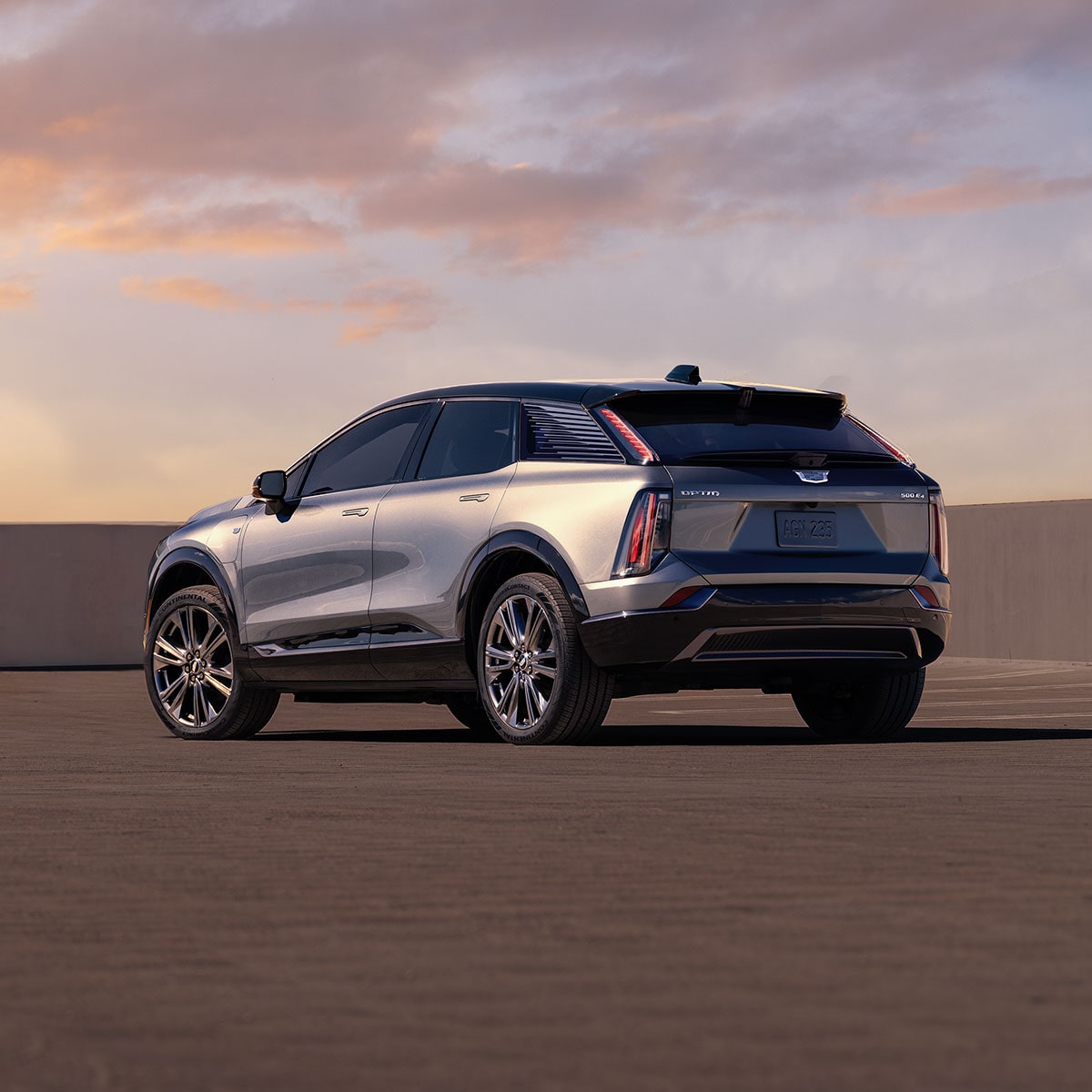 Rear/side view of silver 2025 Cadillac OPTIQ