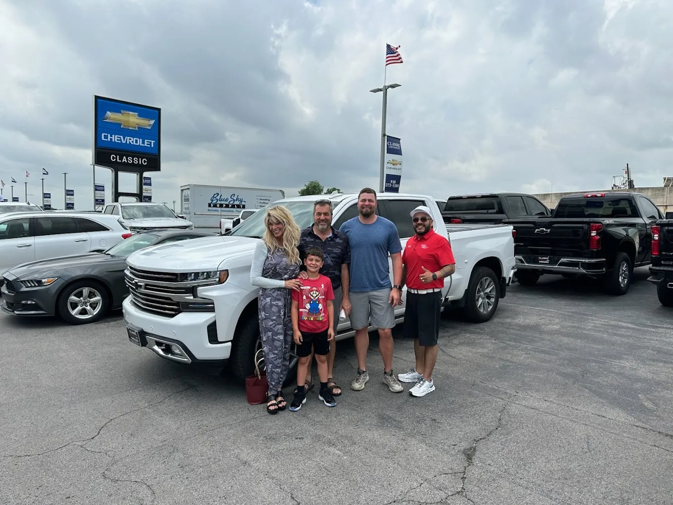 Happy family with vehicle bought from Classic Chevrolet in Owasso, OK