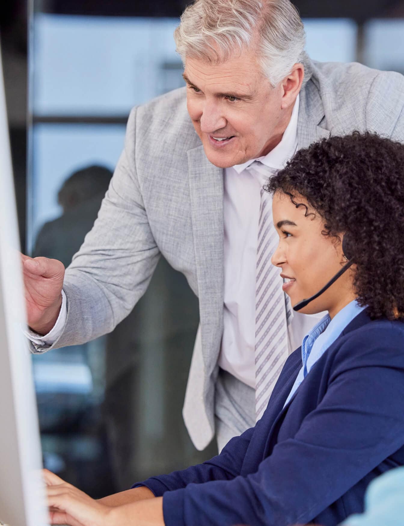Man and Woman looking at a computer screen while speaking