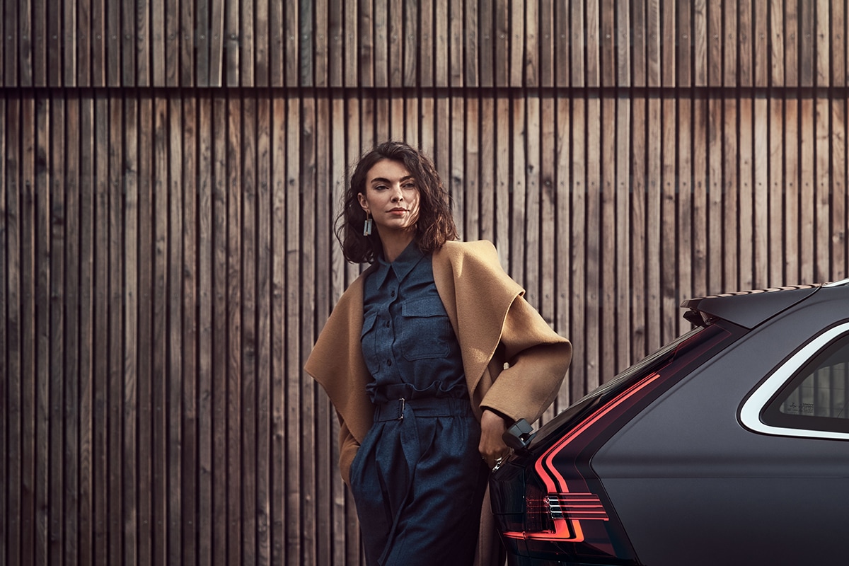 Calculate Your Payment | Accelerate My Deal Woman standing next to the hatch of a Volvo V90
