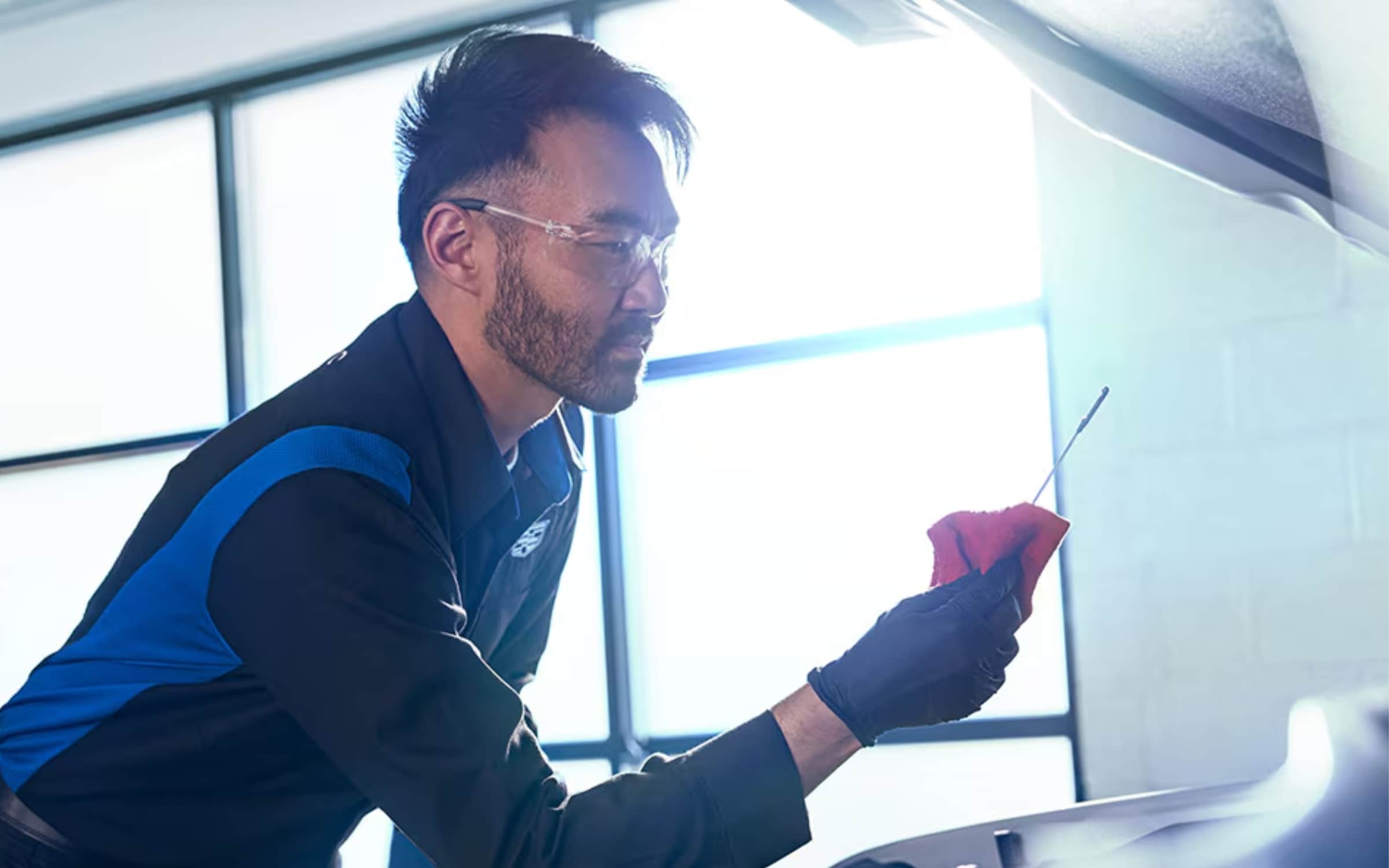 Technician changing oil Technician changing oil