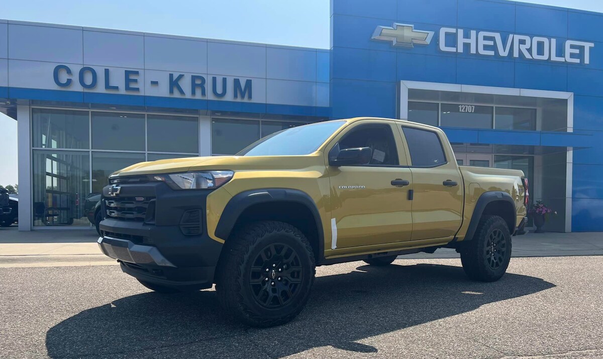 Chevy Colorado parked in front of a Chevy Dealership