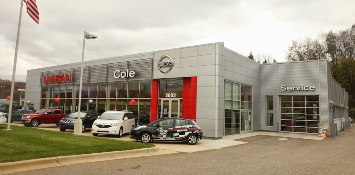 Nissan Dealership with cars parked in front