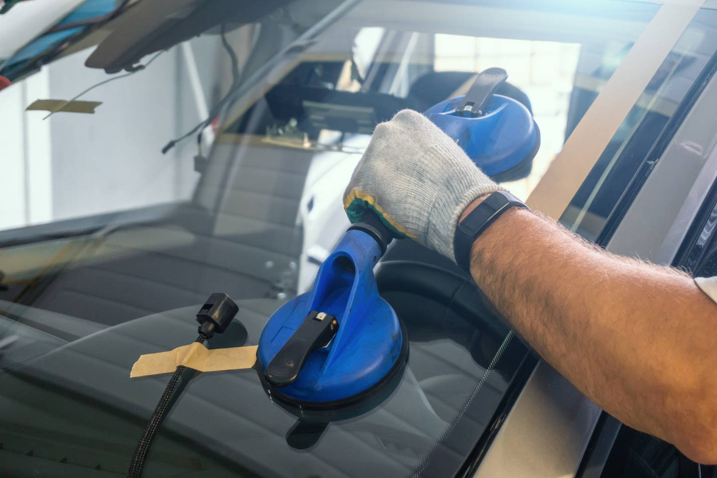 Cadillac mechanic replacing a Cadillac windshield