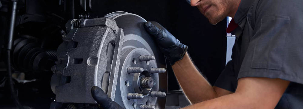 Cadillac Mechanic inspecting a brake pad