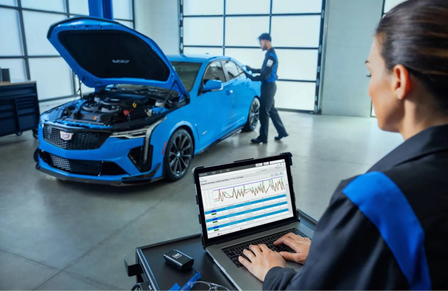 Cadillac mechanic servicing a Cadillac engine