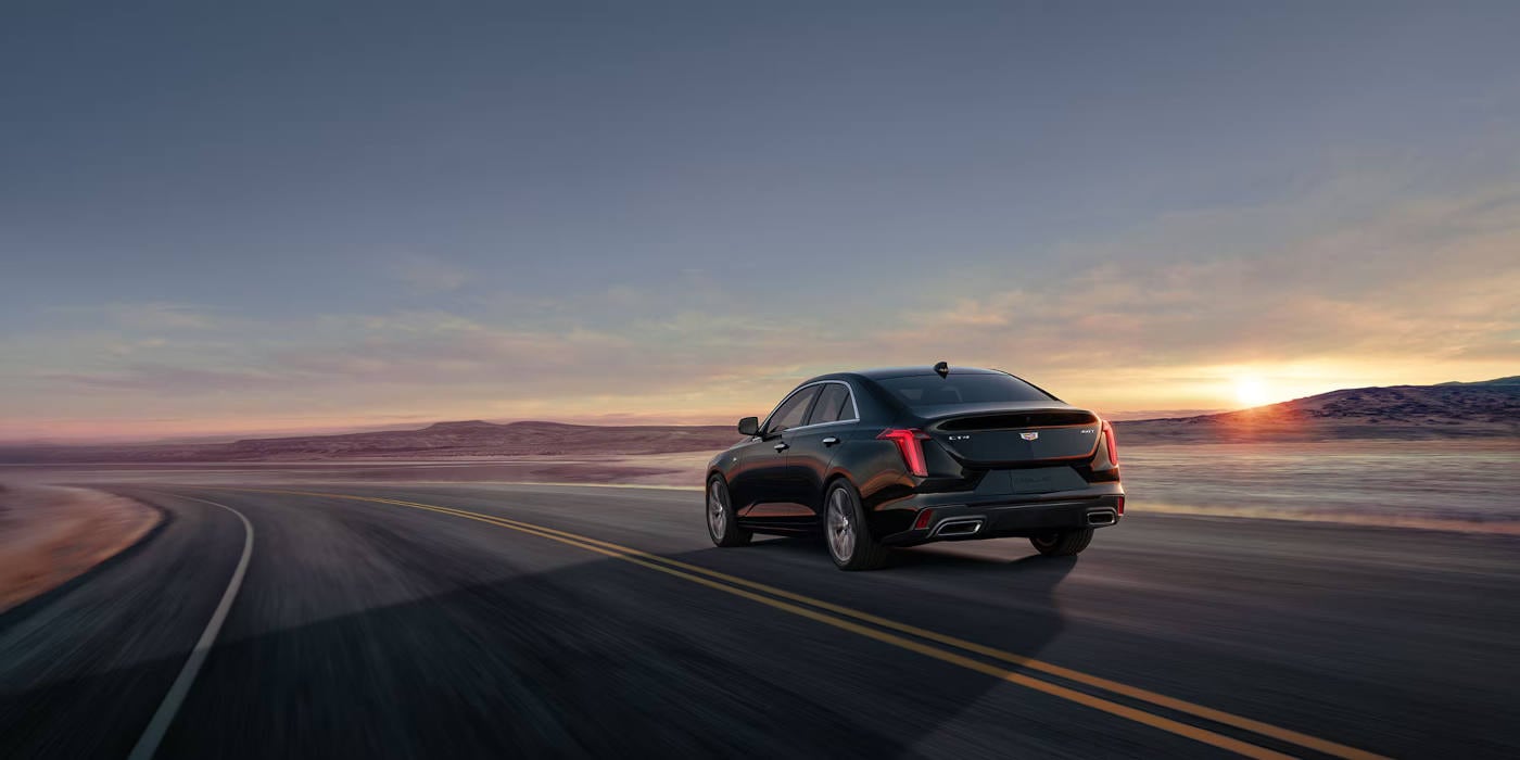 2026 Cadillac CT4 driving around a curve rear view