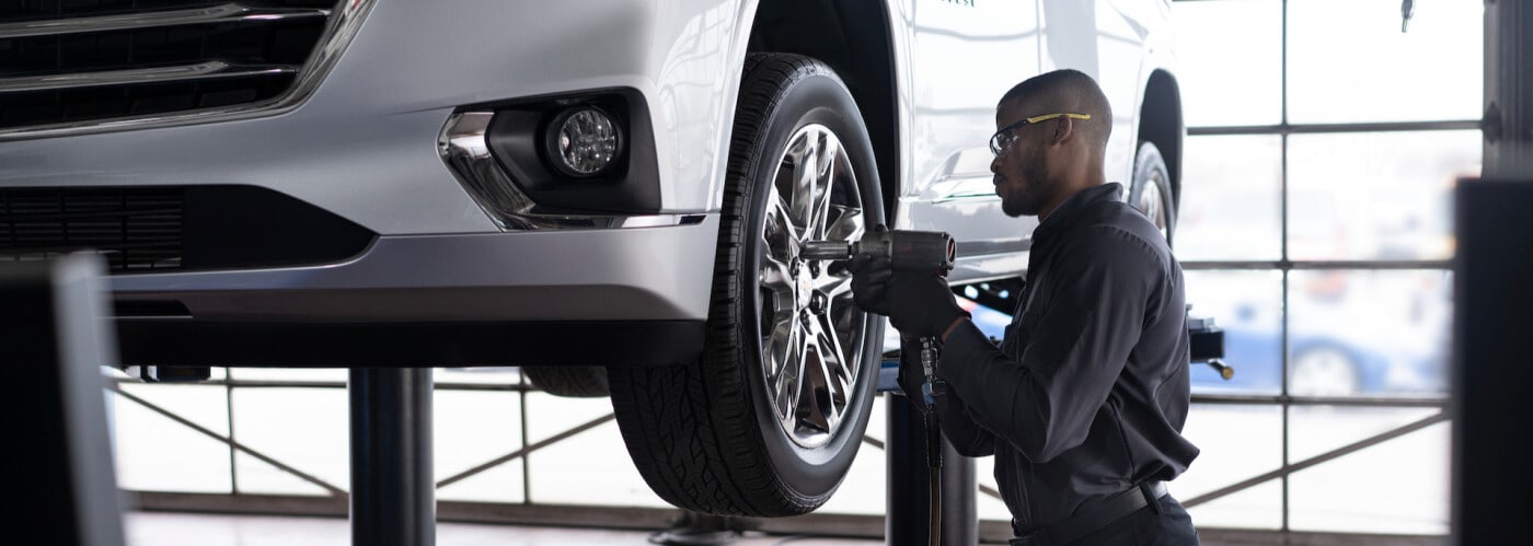 Cadillac mechanic servicing tire