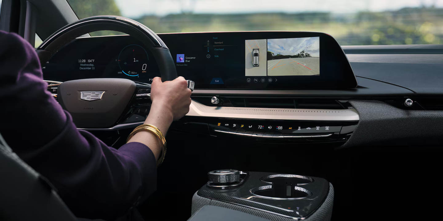 Cadillac steering wheel and dashboard with a women driving