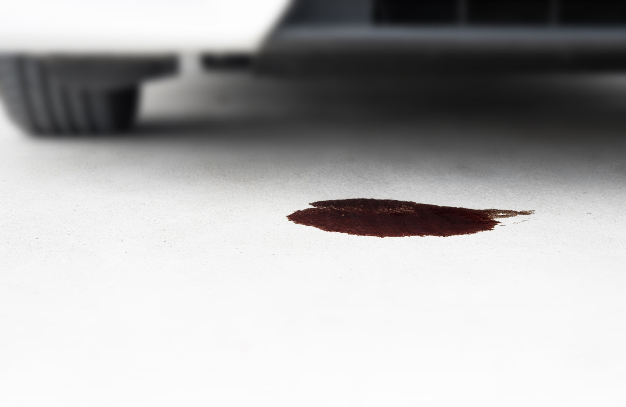 Oil leaking from a vehicle onto a garage floor