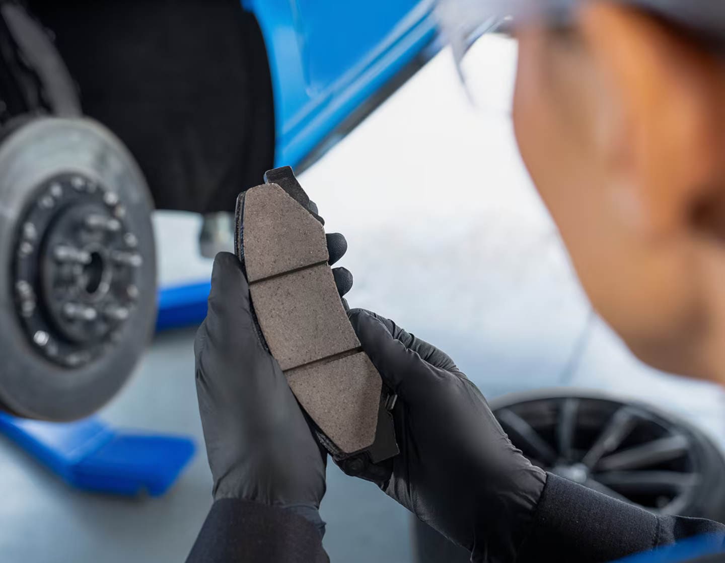 Cadillac technician inspecting brake pads