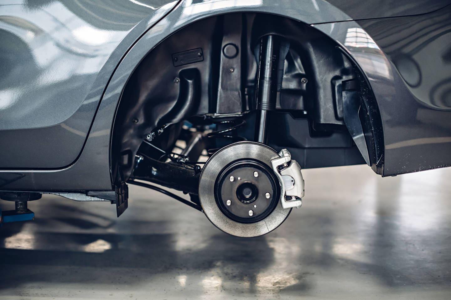 close up of a car wheel well with tire removed