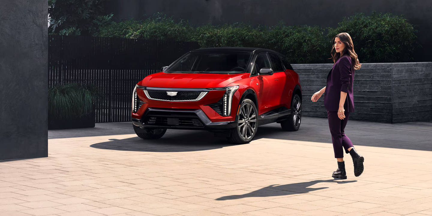 women walking toward a 2026 Cadillac OPTIQ