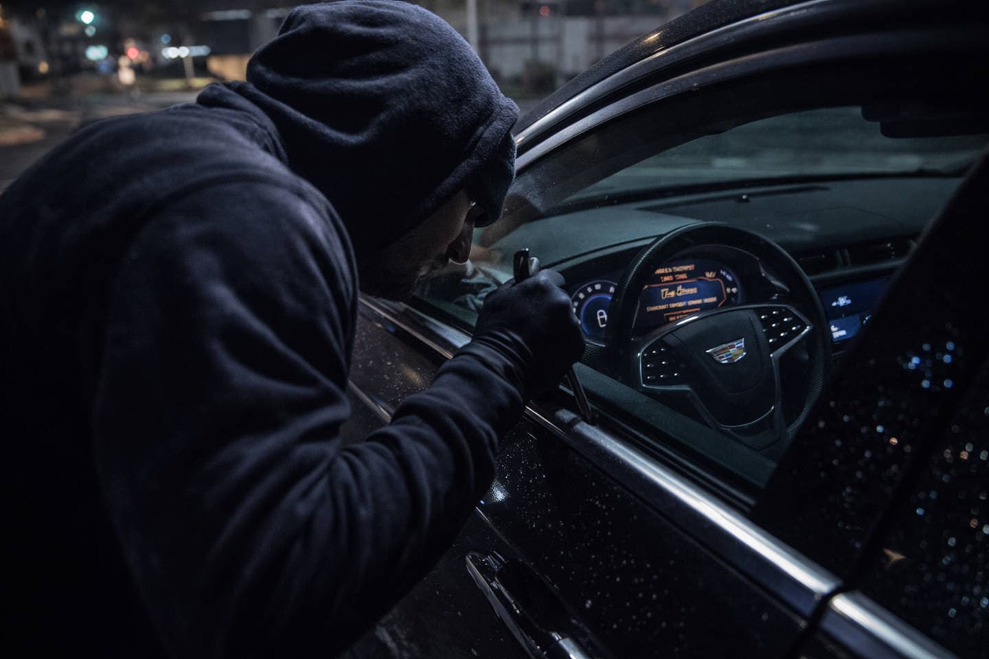 Man trying to break into a Cadillac