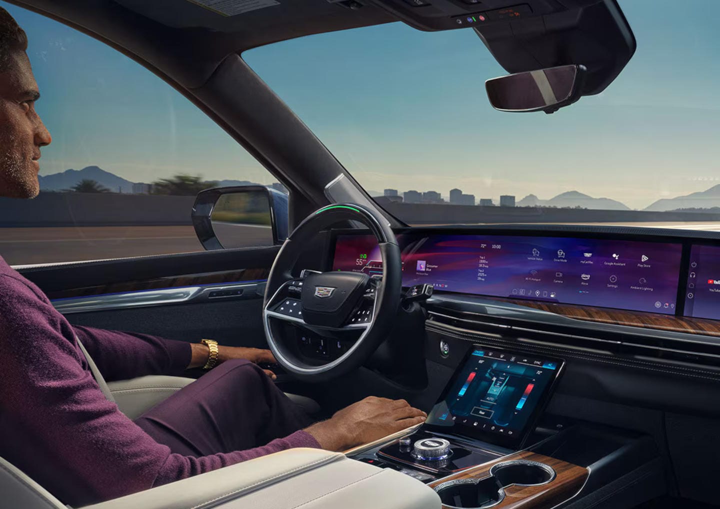 Man sitting in a Cadillac driver's seat utilizing super cruise