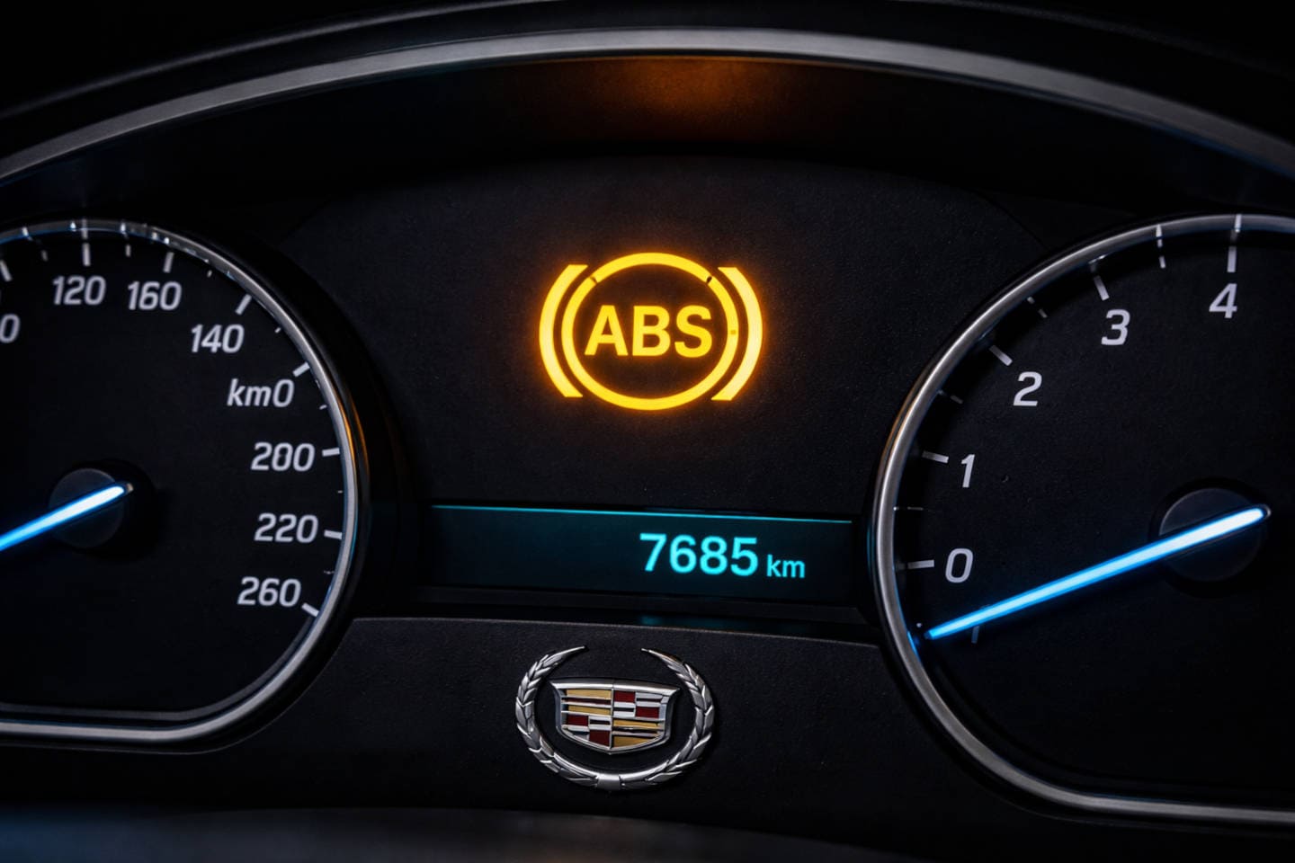 Close up of a Cadillac dashboard with the ABS light on