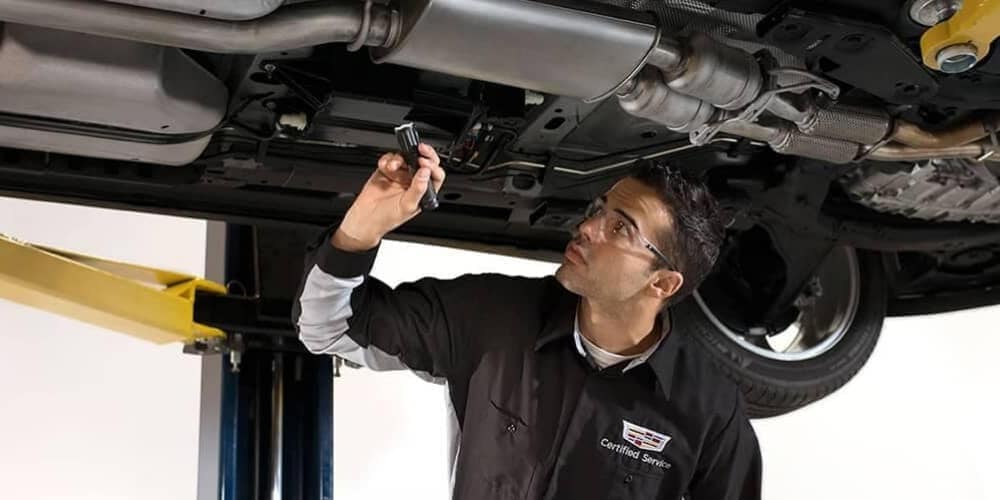 Picture of mechanic servicing a Cadillac