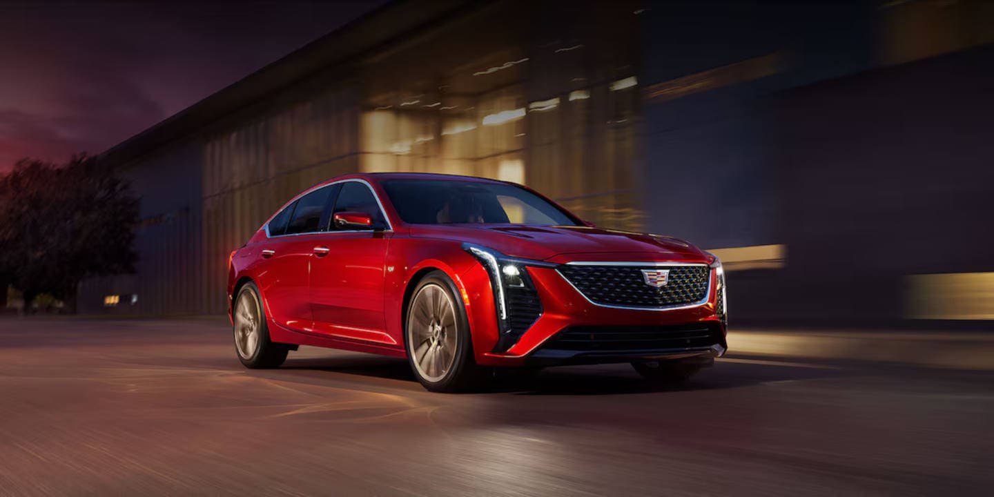 Cadillac driving through the city at night