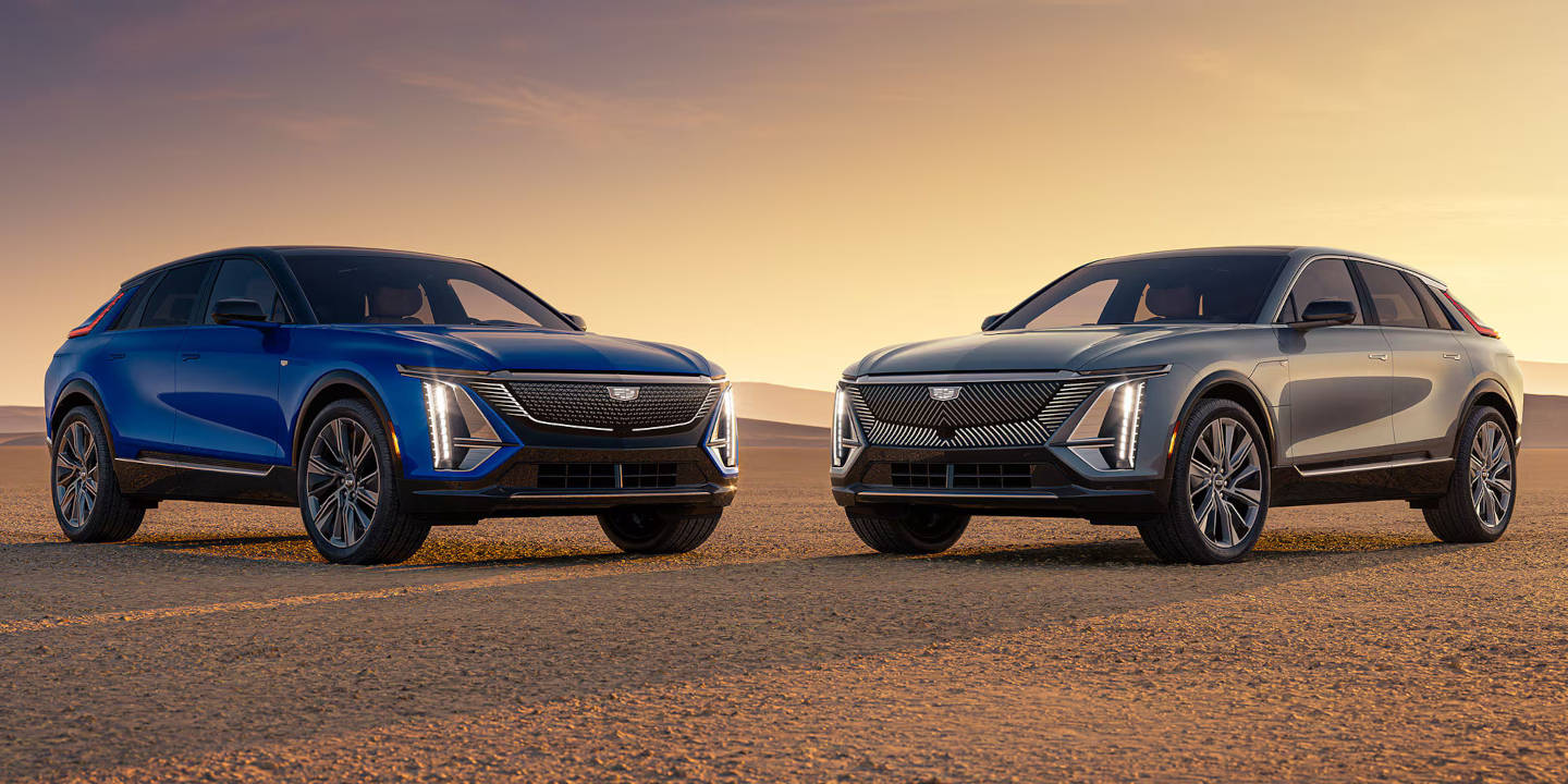 Two Cadillac LYRIQs parked with sunset in the background