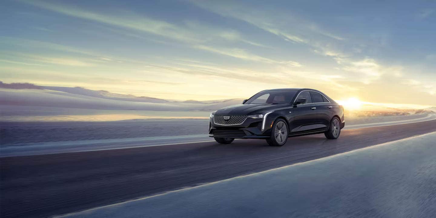 Cadillac CT4 driving with Sunset in the background