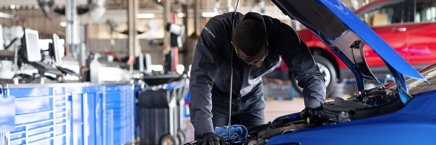 Chevy mechanic working under the hood
