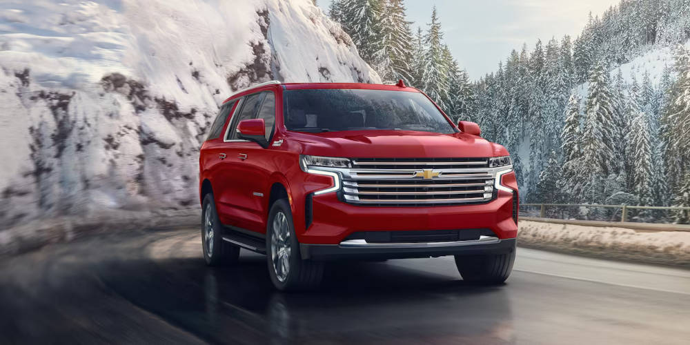 2024 Chevy Suburban driving through the mountains in the winter