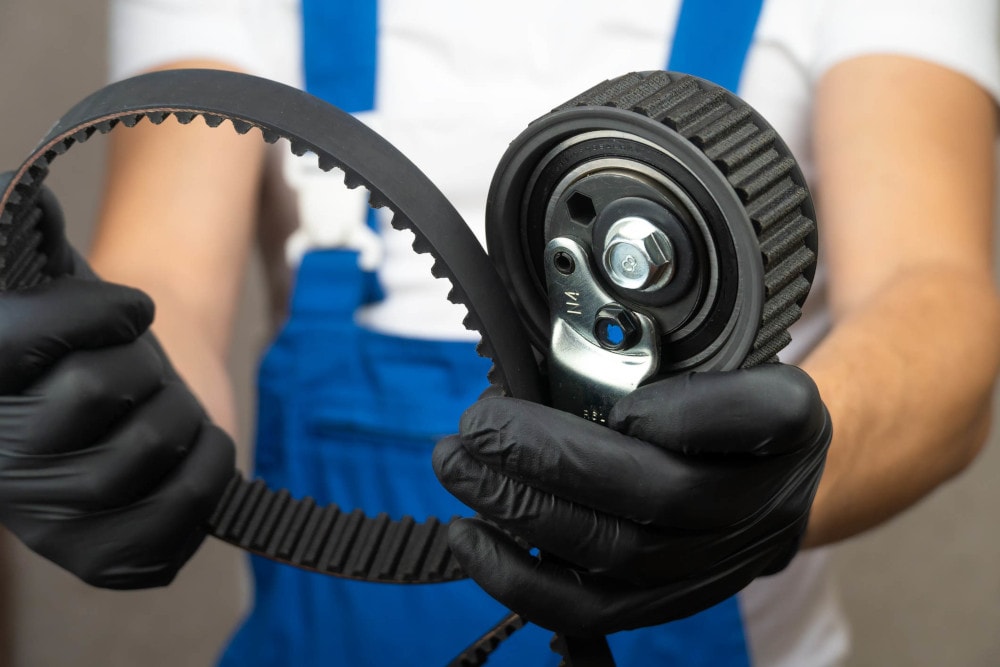 Chevy mechanic doing a serpentine belt replacement