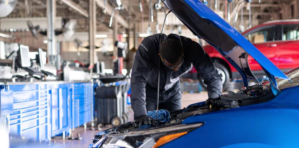 Mechanic leaning over a chevy engine