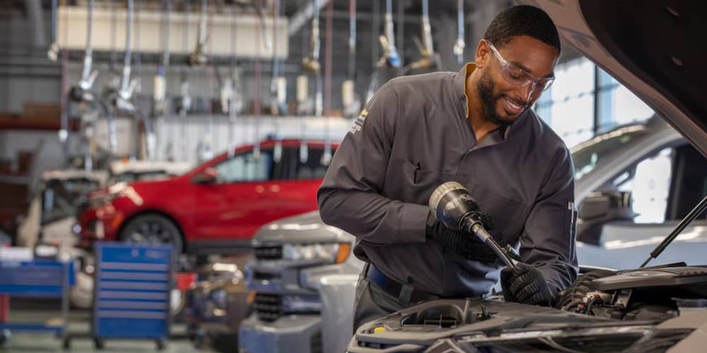Chevy mechanic working on an engine