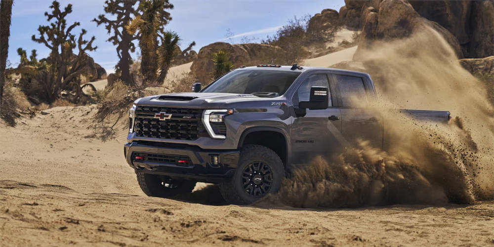 2024 Chevy Silverado 3500 HD driving through the desert