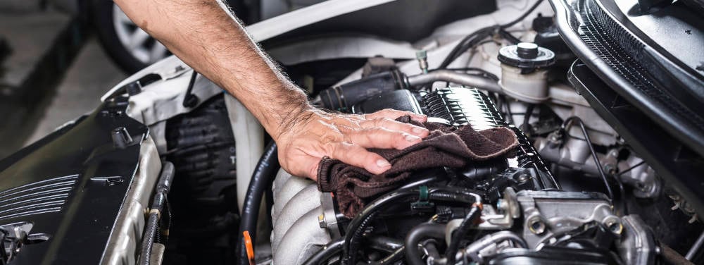 Hyundai Engine being cleaned with a towel