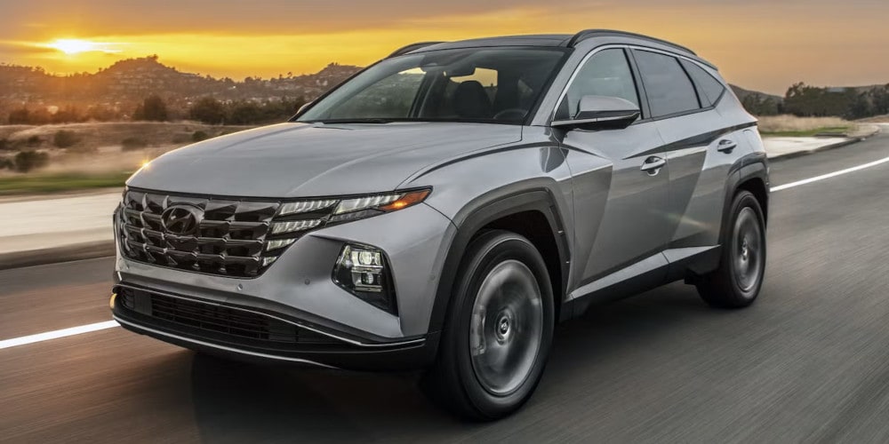 2024 Hyundai Tucson Hybrid driving down the road