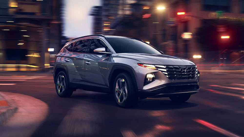 Hyundai Tucson driving around a corner at night