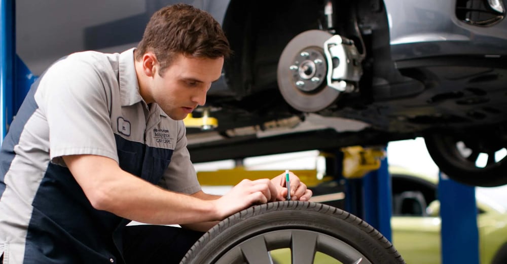 hyundai mechanic checking a tire