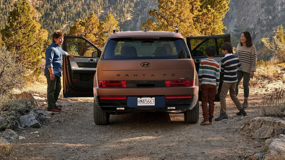 2024 Hyundai Santa Fe Hybrid with a family getting in