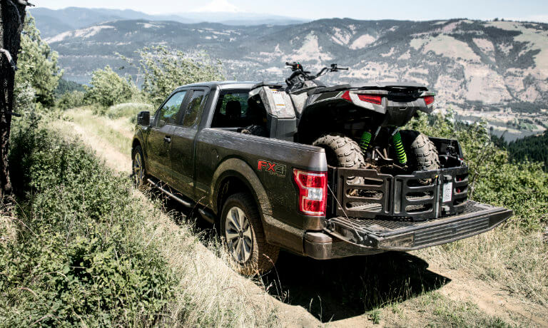 2019 Ford F-150 carrying ATV in truck bed