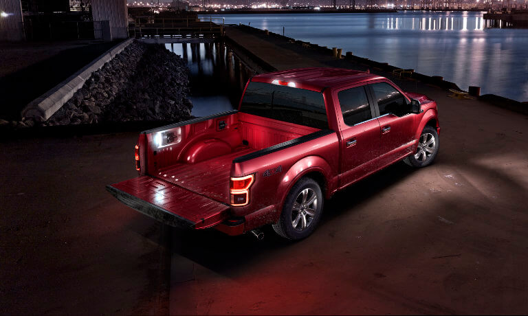 Red 2019 Ford F-150 by water at night