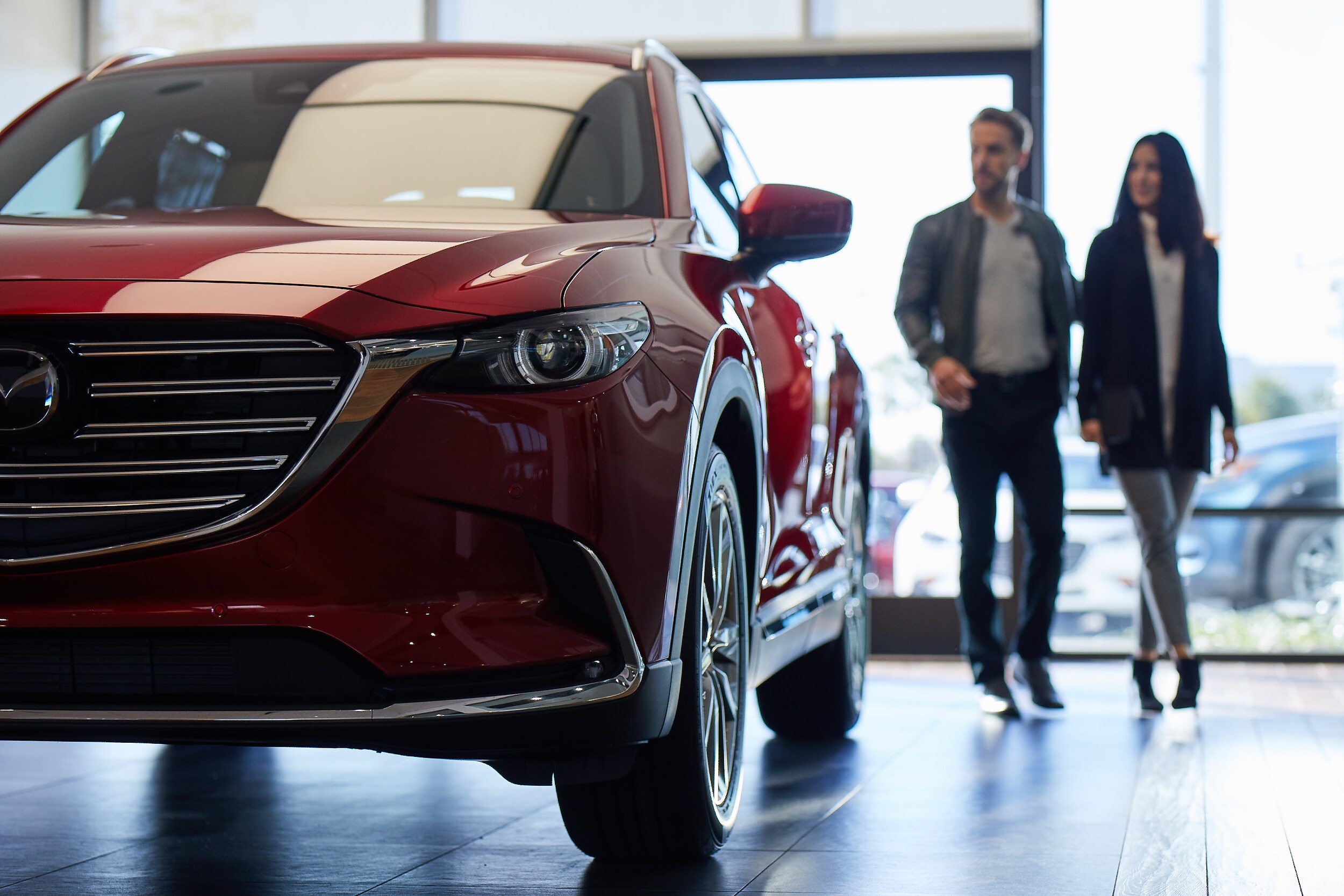  Customer walking Mazda showroom.