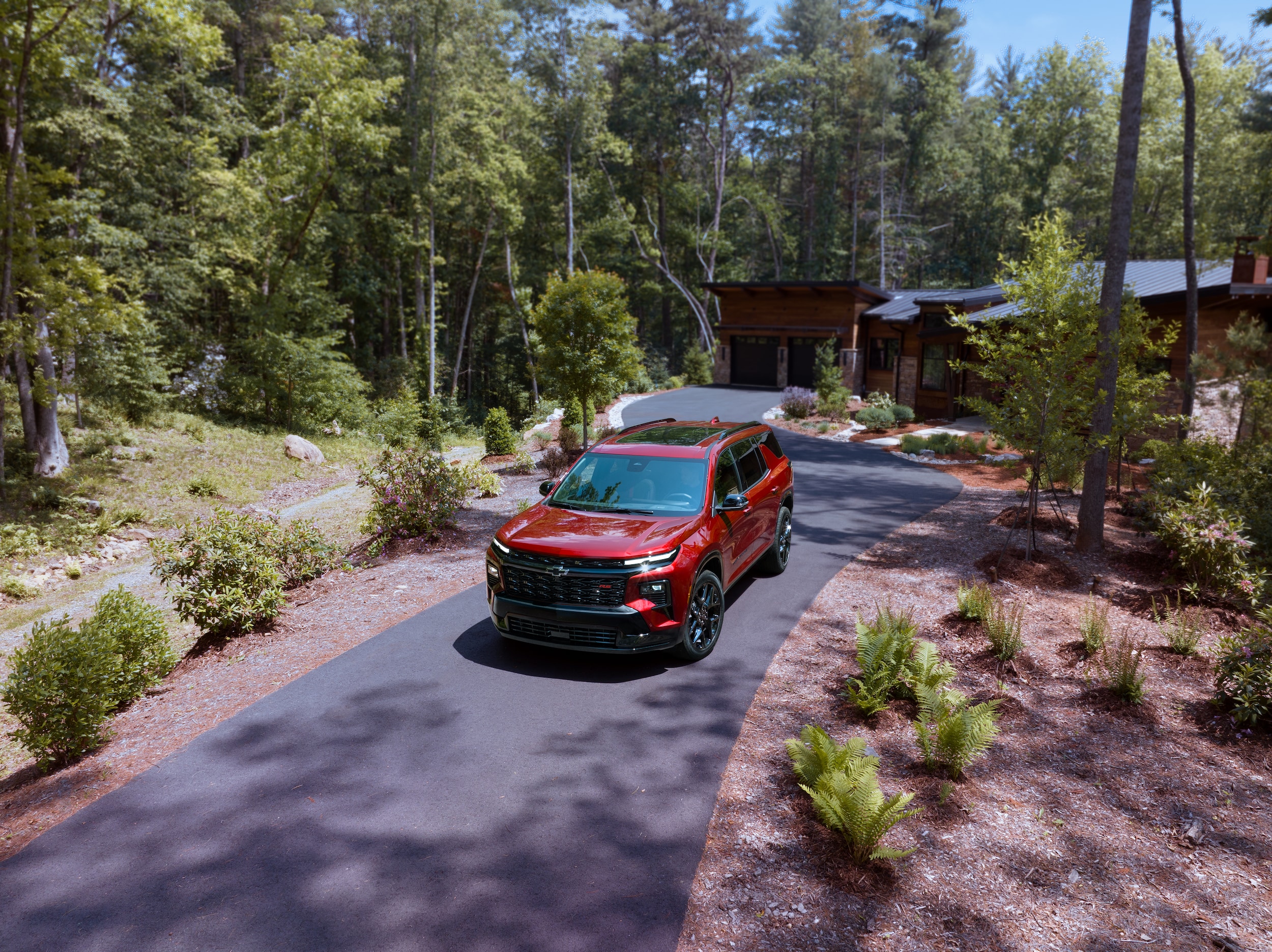 Chevrolet Traverse driving down driveway