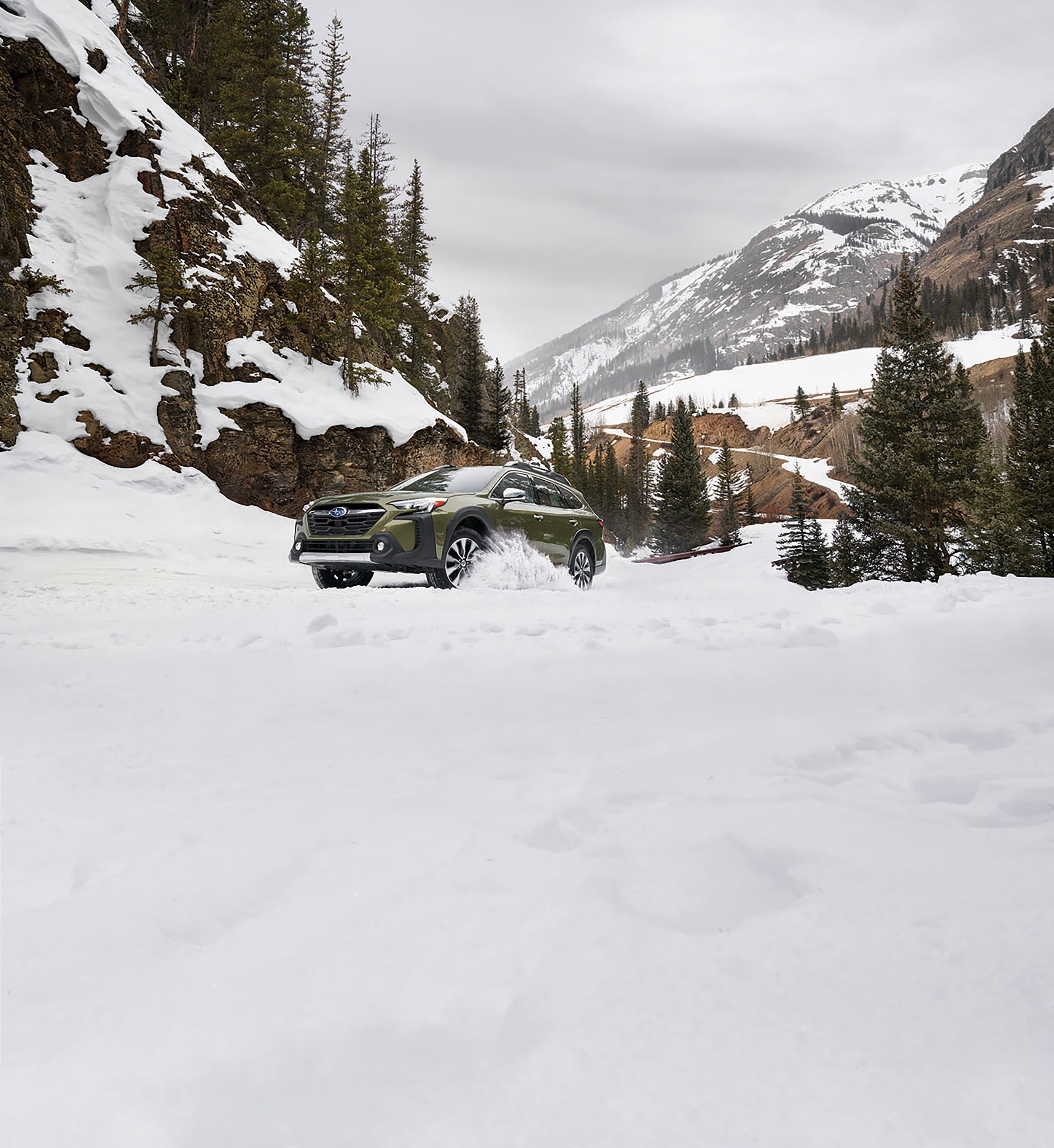 Subaru Outback driving through snow