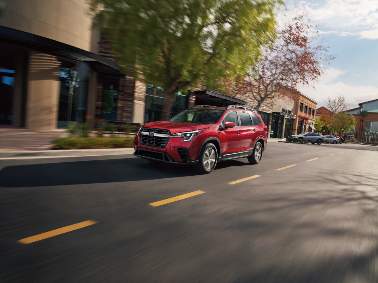 Red Subaru Ascent driving through town