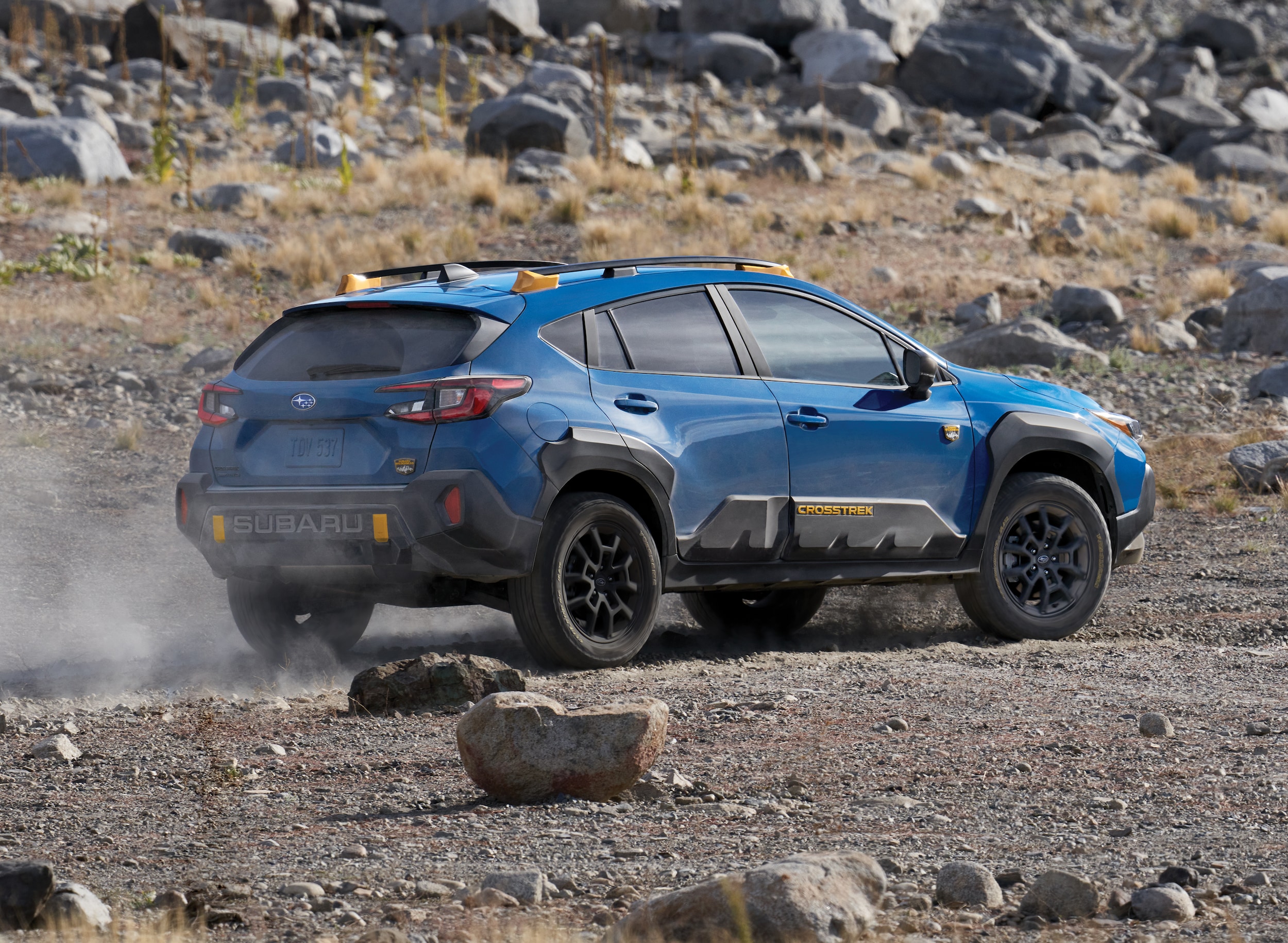 Blue Subaru Crosstrek Wilderness driving on dirt road