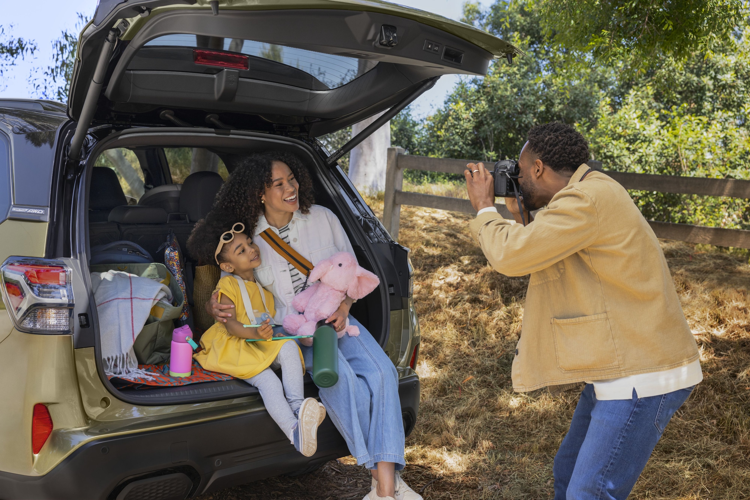 Family sitting in back of Subaru Forester Hybrid