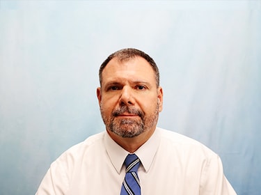 Staff member JOHN SKOKO from 5464b65eac88