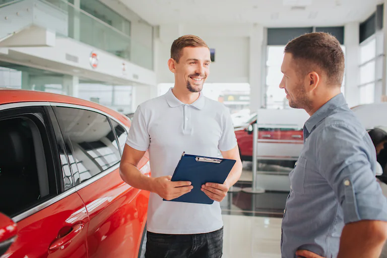 photo-of-a-dealership-employee-helping-a-customer-in-the-showroom.webp