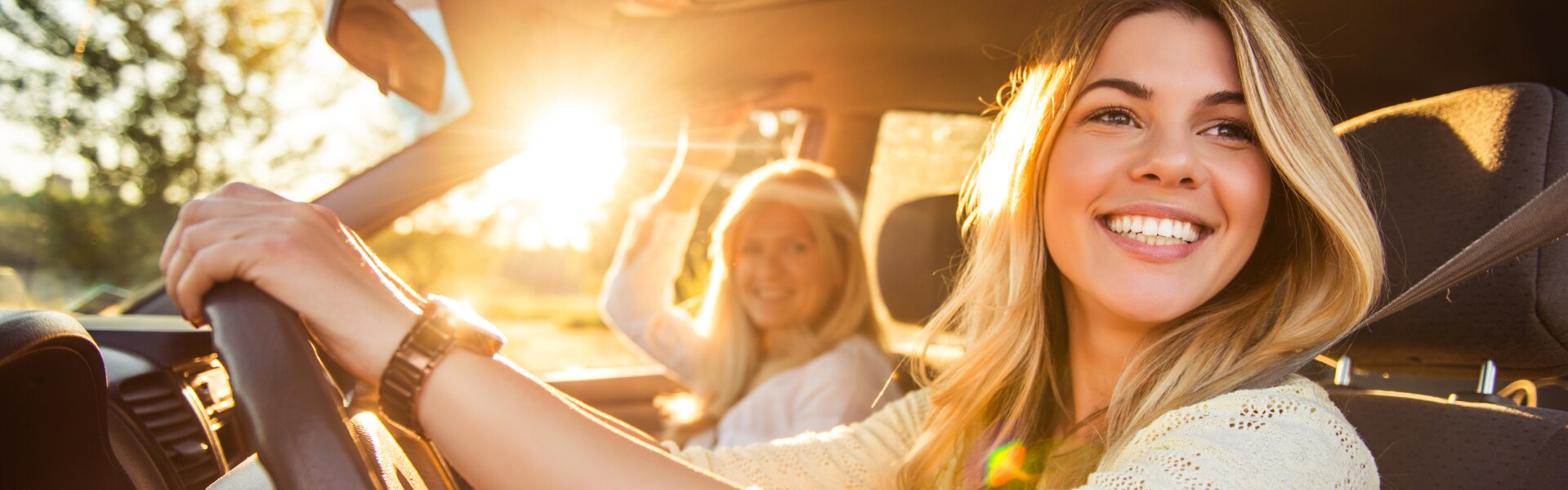 Mother and Daugher driving off in her new car
