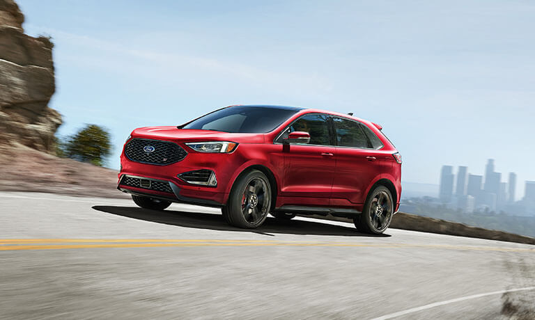 2022 Ford Edge driving away from the city