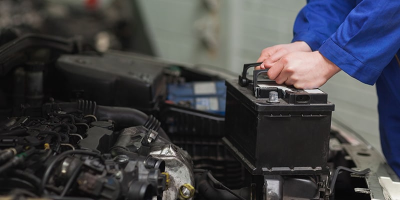 BMW mechanic pouring oil