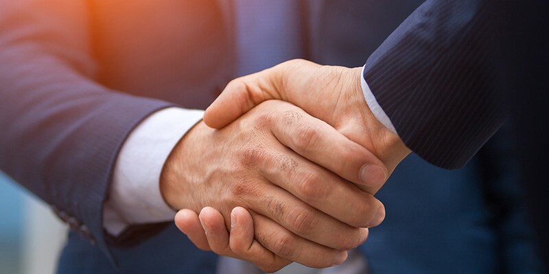 Woman shaking hands with an associate