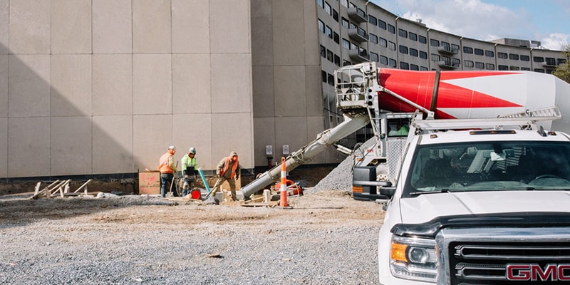 Construction worker sitting in the back of a GMC